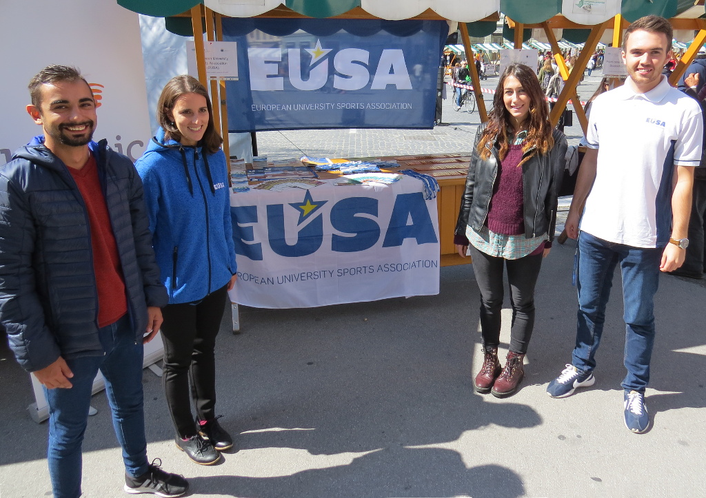 EUSA interns in front of the stand